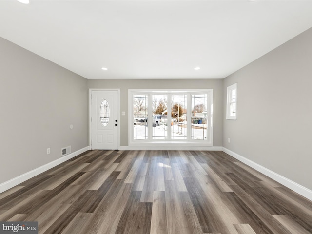 entryway with plenty of natural light and dark hardwood / wood-style floors