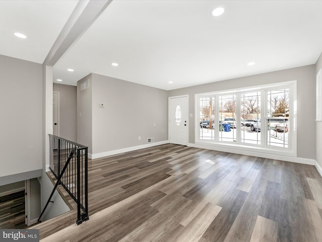 unfurnished living room with dark hardwood / wood-style flooring