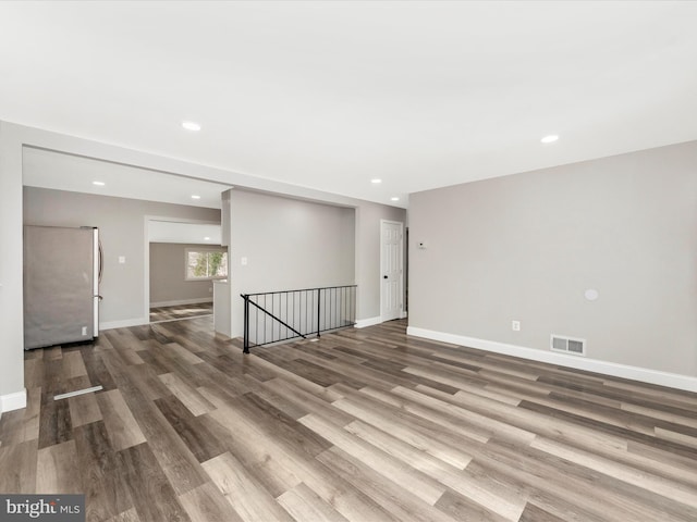 empty room with hardwood / wood-style floors