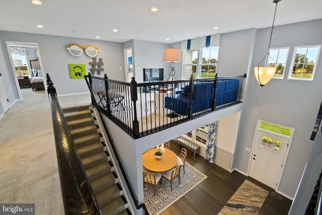 staircase with hardwood / wood-style floors