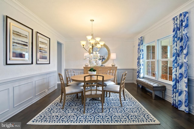 dining area with an inviting chandelier, dark hardwood / wood-style flooring, and crown molding