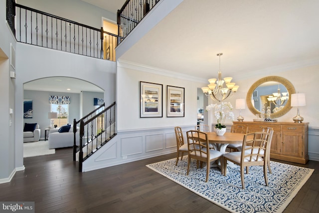 dining room featuring dark hardwood / wood-style flooring, ornamental molding, and a chandelier