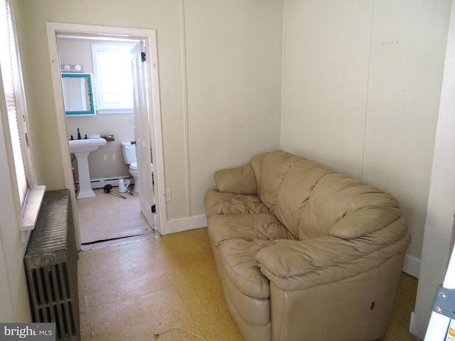 living area with radiator and a baseboard heating unit