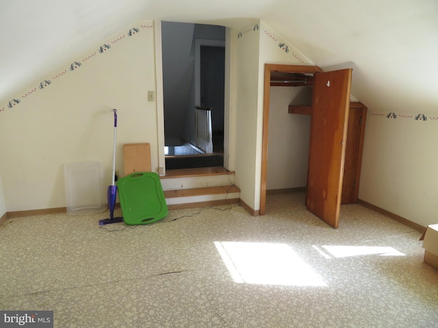 additional living space featuring lofted ceiling