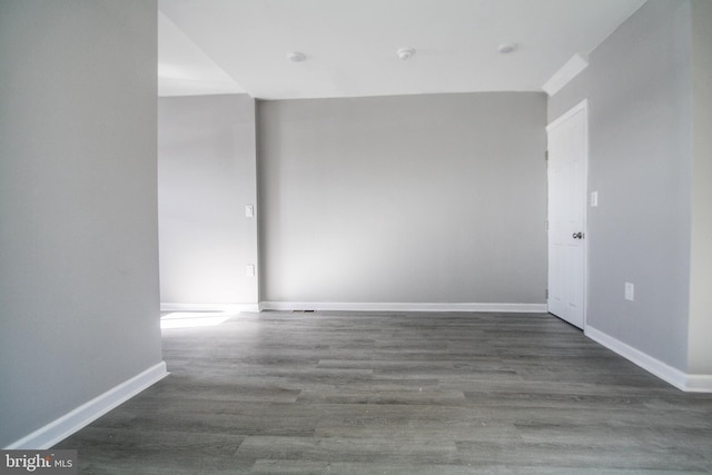 spare room with dark hardwood / wood-style flooring