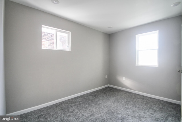 empty room with dark carpet