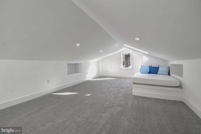 additional living space featuring lofted ceiling and carpet floors