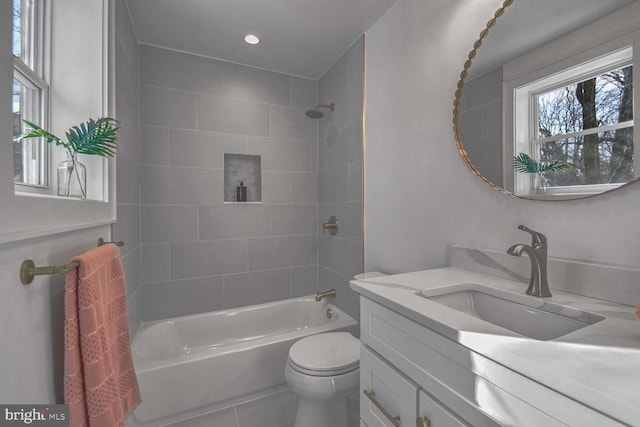 full bathroom featuring vanity, toilet, tile patterned floors, and tiled shower / bath