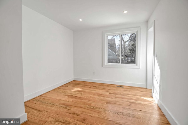 empty room with light hardwood / wood-style flooring