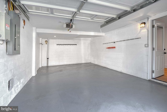 garage with a garage door opener and electric panel