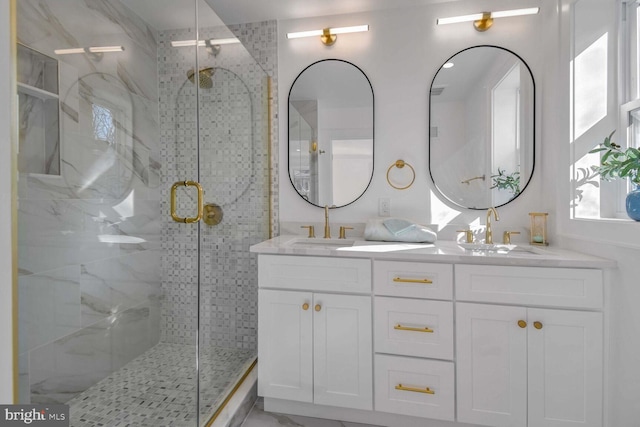 bathroom featuring an enclosed shower and vanity