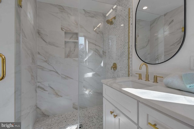 bathroom with vanity and a shower with door