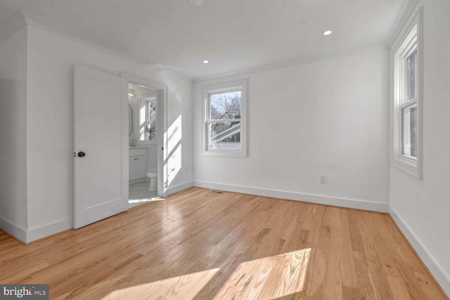 interior space featuring ornamental molding and light wood-type flooring