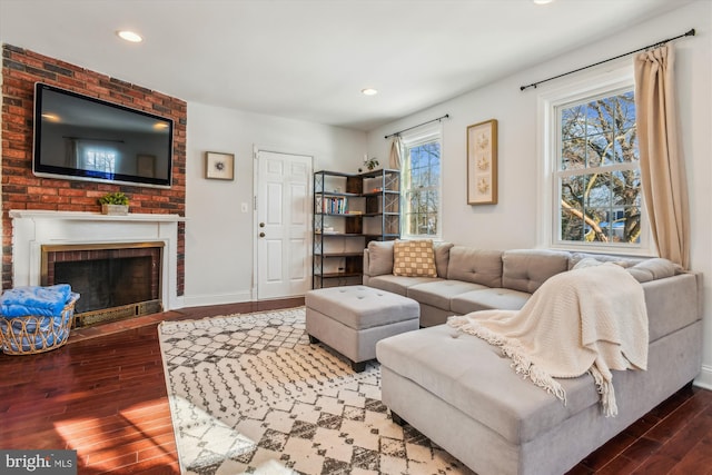 living room with hardwood / wood-style flooring and a fireplace