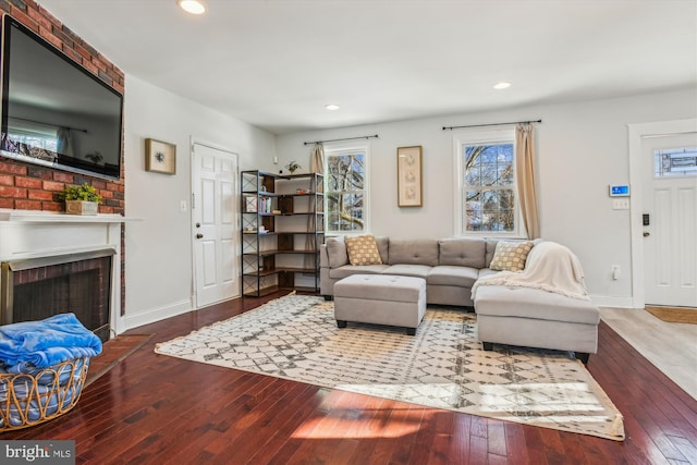 living room with plenty of natural light, a fireplace, and hardwood / wood-style floors