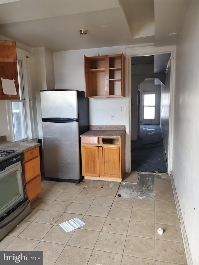 kitchen with light tile patterned floors and stainless steel appliances