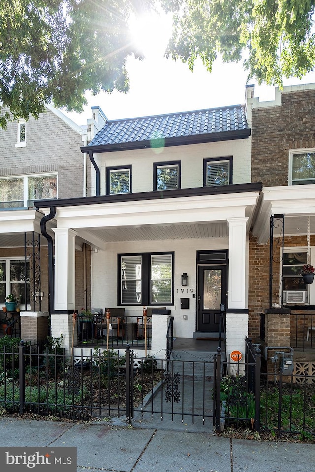 view of front of house featuring covered porch and cooling unit