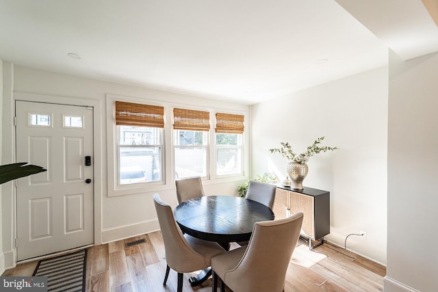 dining space with light hardwood / wood-style flooring