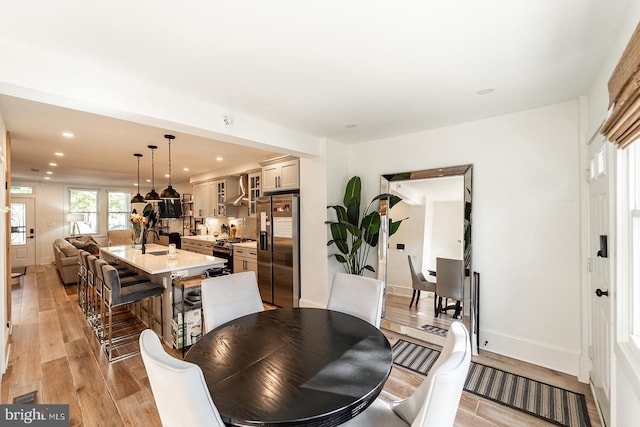 dining space featuring light hardwood / wood-style floors and sink