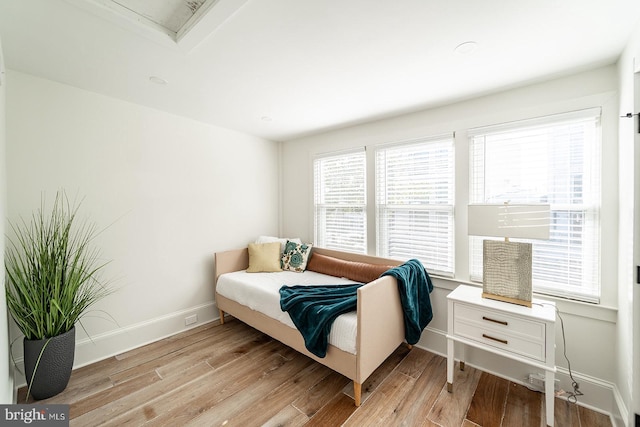 bedroom with light hardwood / wood-style flooring and multiple windows