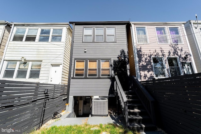 rear view of house with central AC