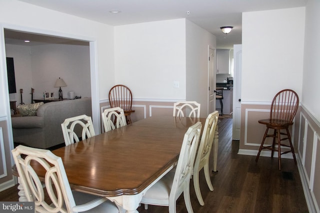 dining space featuring dark wood-type flooring