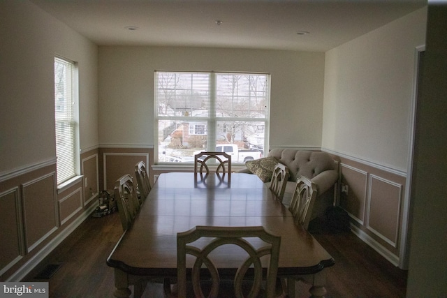 dining room with plenty of natural light and dark hardwood / wood-style flooring