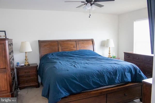 bedroom featuring light carpet and ceiling fan