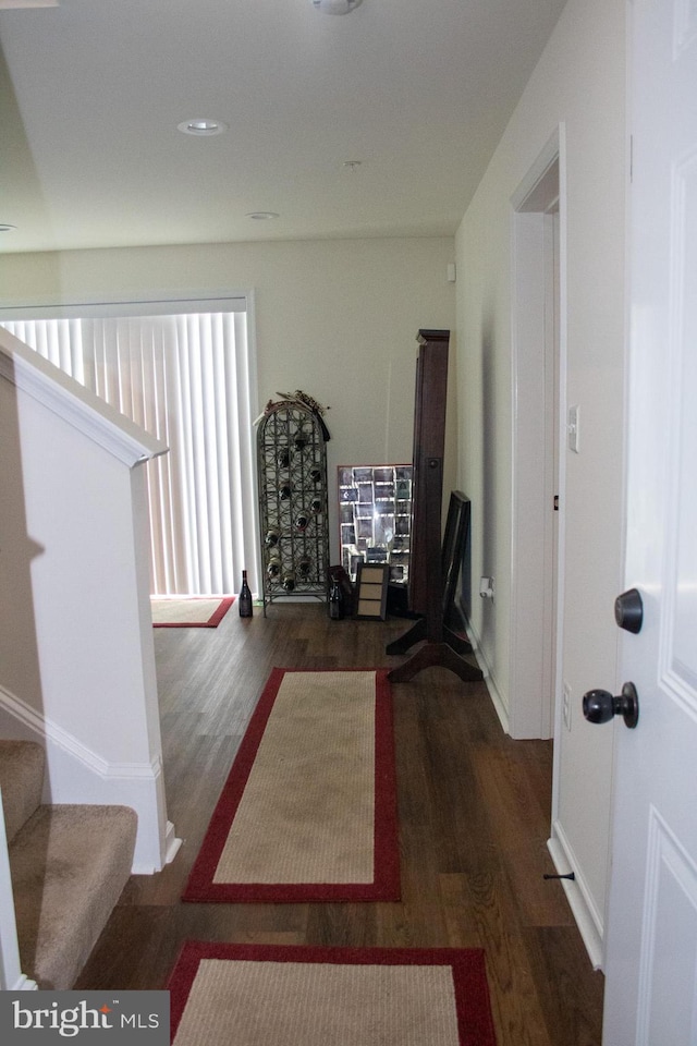 hall with dark wood-type flooring