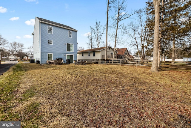 rear view of house with a lawn