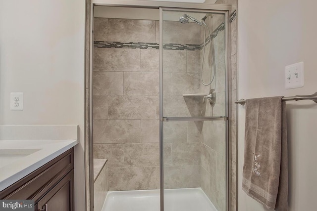 bathroom featuring an enclosed shower and vanity