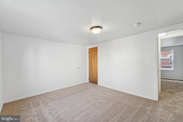 empty room featuring light colored carpet