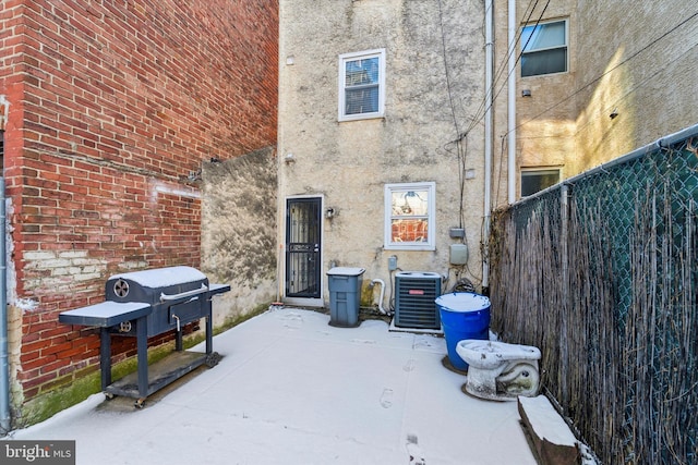 view of patio with central air condition unit and area for grilling