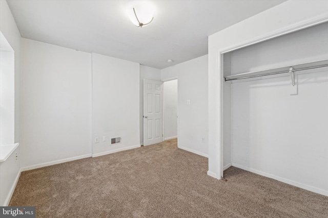 unfurnished bedroom featuring a closet and carpet flooring