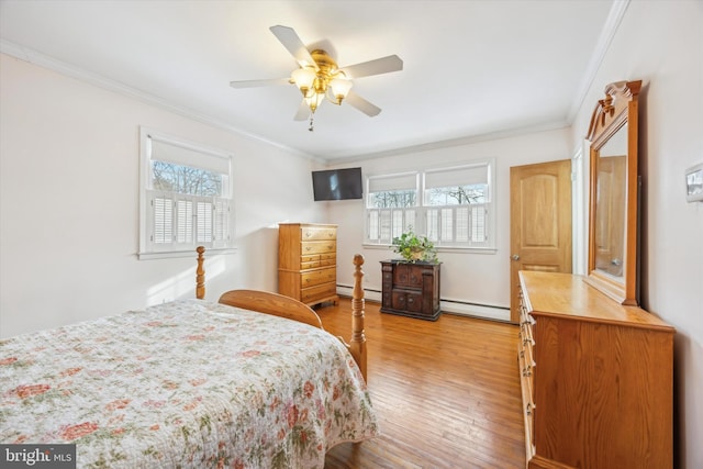 bedroom with a baseboard radiator, multiple windows, ceiling fan, and ornamental molding