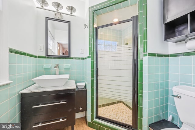 bathroom with a shower with shower door, tile walls, and toilet