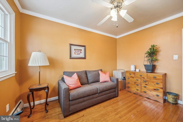 living room with crown molding, hardwood / wood-style flooring, ceiling fan, and a baseboard heating unit