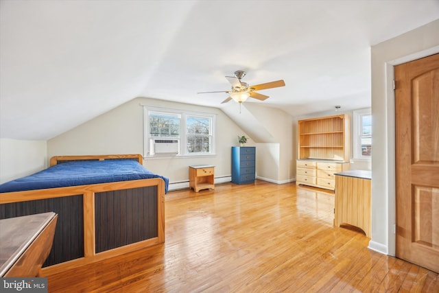 unfurnished bedroom with ceiling fan, a baseboard heating unit, lofted ceiling, and light wood-type flooring