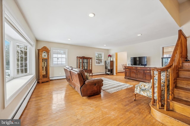 living room featuring baseboard heating and light wood-type flooring