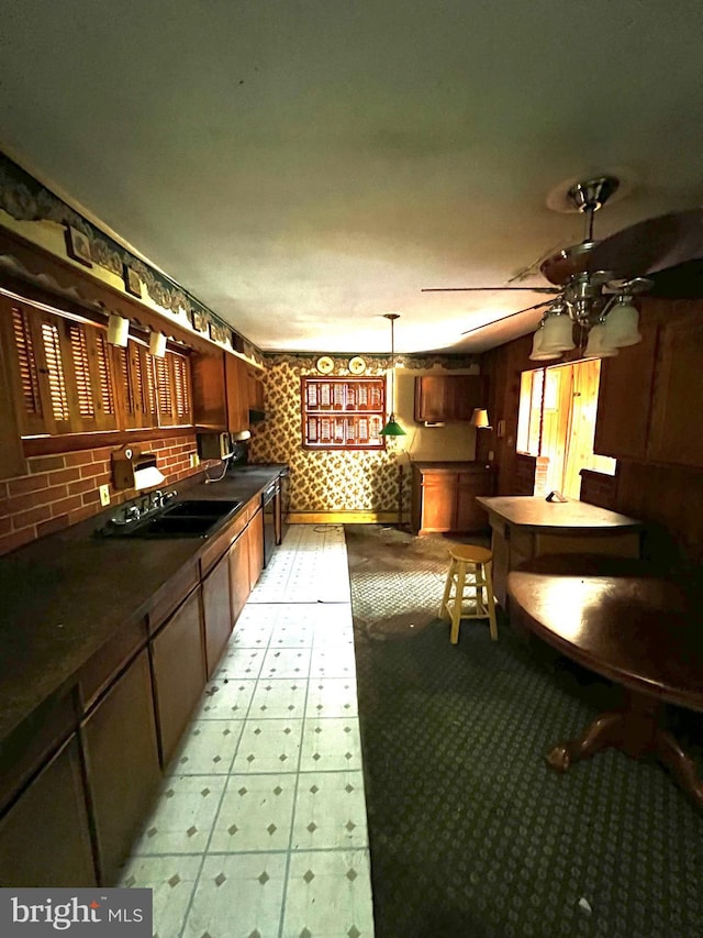 kitchen with ceiling fan, black dishwasher, pendant lighting, and sink