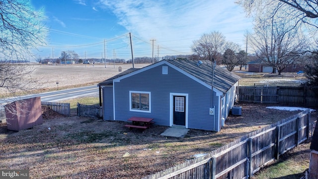 rear view of property with central AC unit