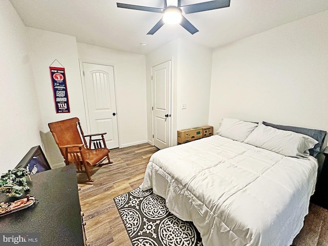 bedroom featuring a ceiling fan and wood finished floors