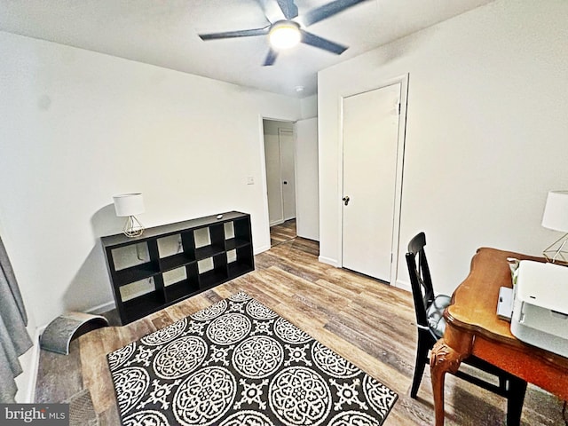 office with ceiling fan, baseboards, and wood finished floors