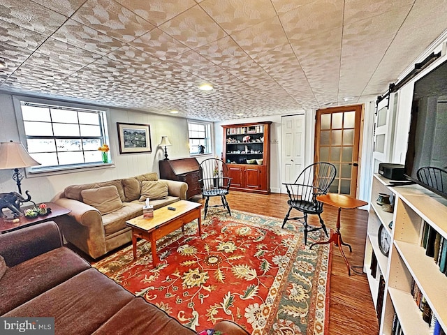 living area with a healthy amount of sunlight and wood finished floors