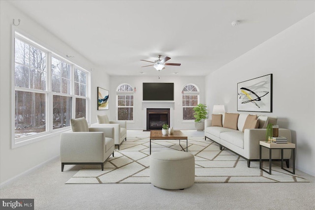 carpeted living room featuring ceiling fan