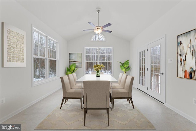 tiled dining space with ceiling fan and vaulted ceiling