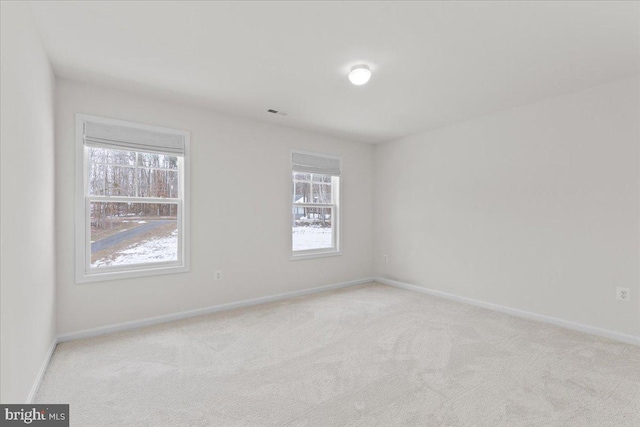 unfurnished room with light colored carpet