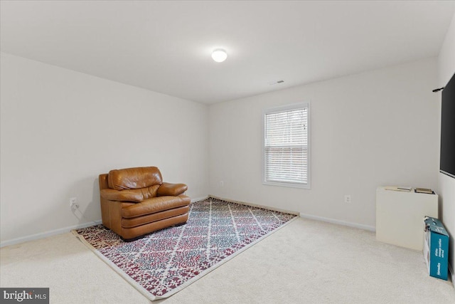 sitting room featuring light colored carpet