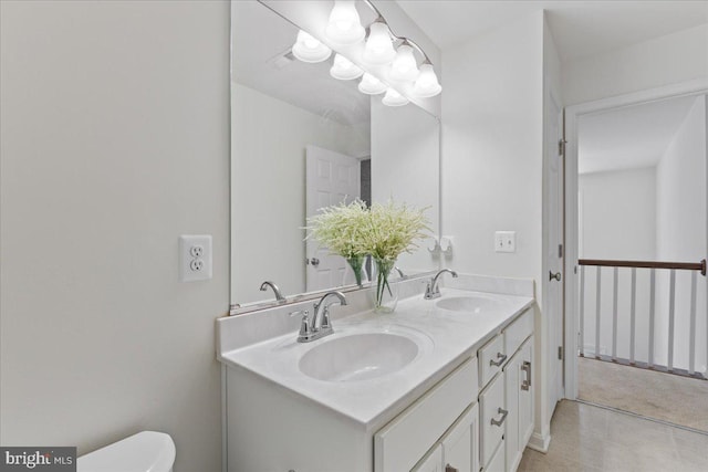 bathroom featuring toilet and vanity