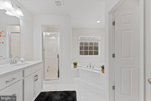 bathroom featuring vanity, tile patterned floors, and shower with separate bathtub